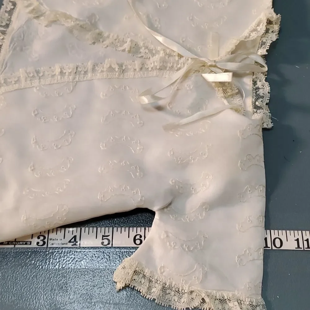 Vintage baby dress with jacket. Trimmed in lace with tie. The jacket has enbroid